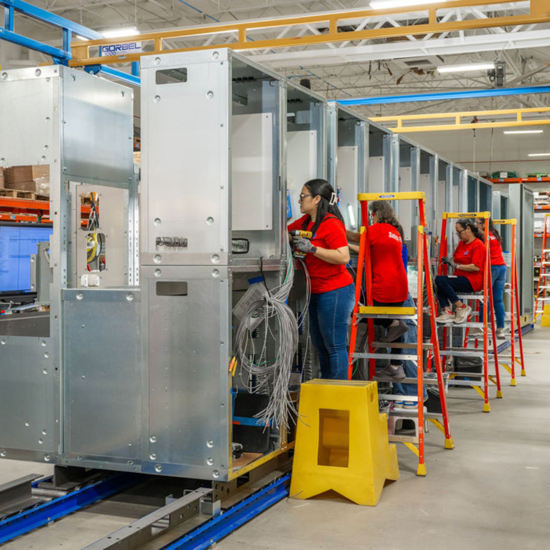 Workers assembling switchgear units at JST Power Equipment’s Lake Mary, Florida manufacturing facility.