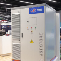 Front view of JST Powers’ Battery Energy Storage System cabinet with control panel and safety indicators at at Ennovation 2025 in Salzburg, Austria. JST Power Equipment BESS cabinet labeled “JST STORE” at Ennovation 2025 in Salzburg, Austria.