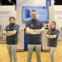 The JST Power Equipment team representing innovation and expertise at Ennovation 2025, Messezentrum Salzburg, Austria JST Power Equipment team with their arms crossed at Ennovation 2025 booth with displays of their equipment