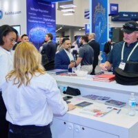 JST Power Equipment staff engaging with attendees at DISTRIBUTECH 2025 trade show booth