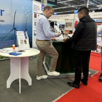 Juan Exposito engages with an attendee at JST’s RE+ Mexico 2025 booth, highlighting the company’s trusted electrical power solutions. Juan Exposito of JST speaking with an attendee at the JST booth during RE+ Mexico 2025