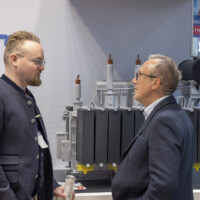 JST Power connects with industry professionals at The Smarter E Europe 2025, presenting cutting-edge photovoltaic and energy storage technology. JST Power Equipment team member discussing energy storage solutions with two attendees at The Smarter E Europe 2025 booth.